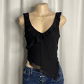 Black v-neck short blouse with ruffled trim and sheer asymmetrical hem