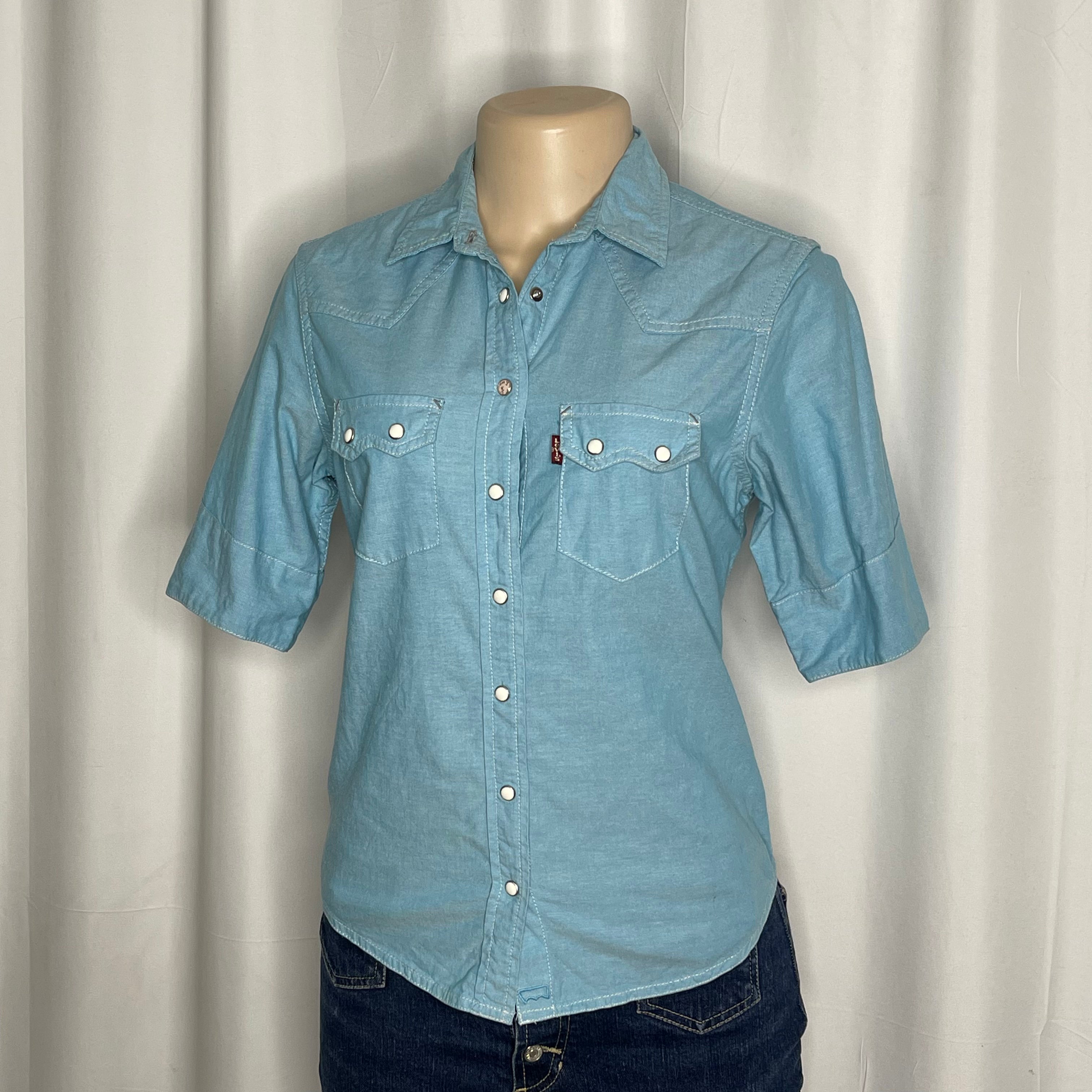Light blue cotton shirt with a pearl snap buttons